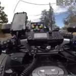 Santa Fe police motorcycle officer pursuing a runaway horse during a downtown parade chase