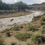 Floodwater covers a road in the Southwest as storms trigger rescues and deadly flash flooding