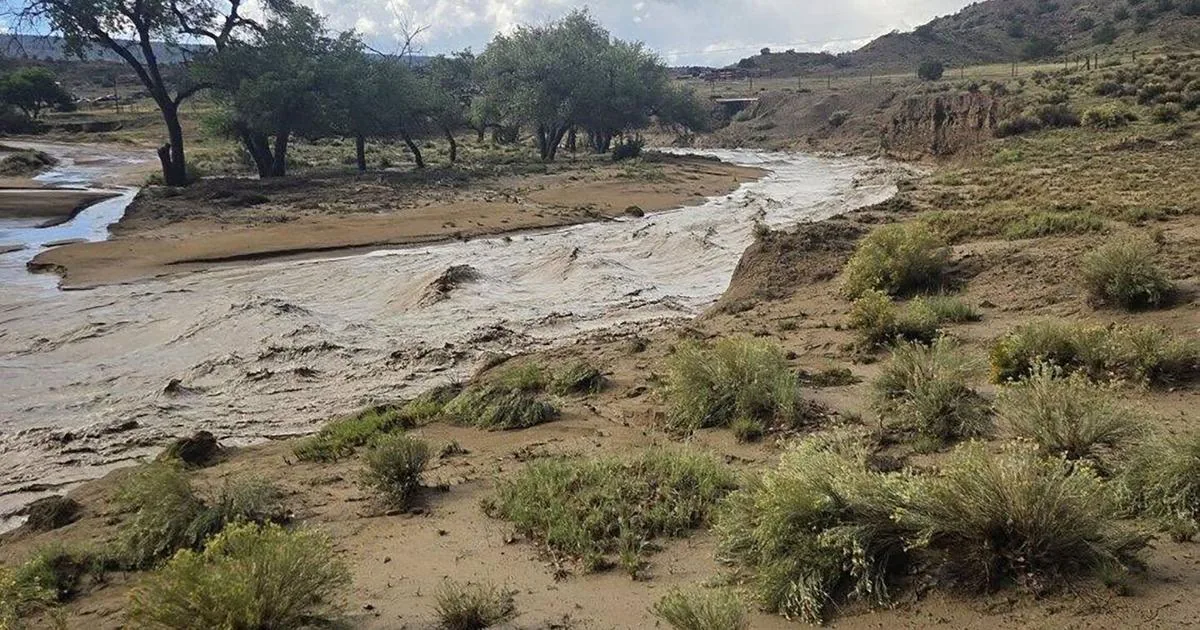 Floodwater covers a road in the Southwest as storms trigger rescues and deadly flash flooding