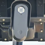 A license plate reader camera mounted on a pole beside a roadway