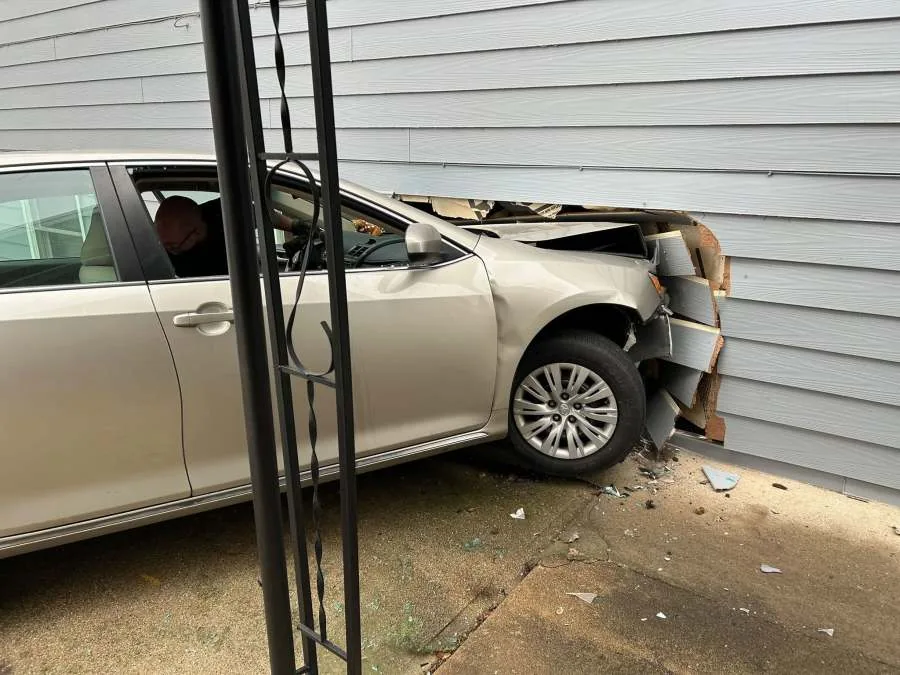 Police responded after a car crashed into an apartment complex at a Canton intersection